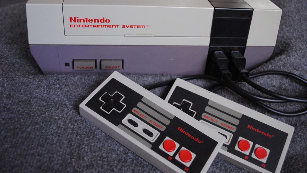 Nintendo's 8-bit Nintendo Entertainment System (NES) from 1985 with two wired controllers.