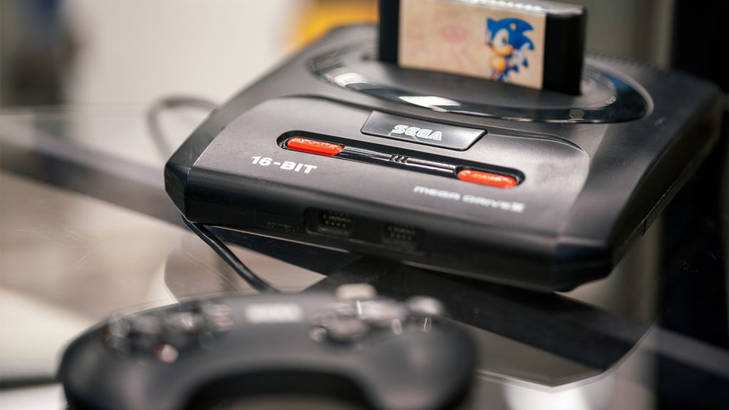 Sega Games' 16-bit game console with a Sonic the Hedgehog game cartridge inserted.