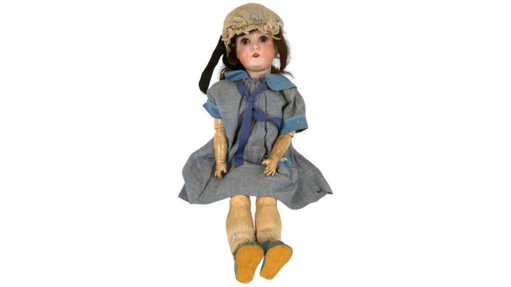 Antique doll in a blue dress.