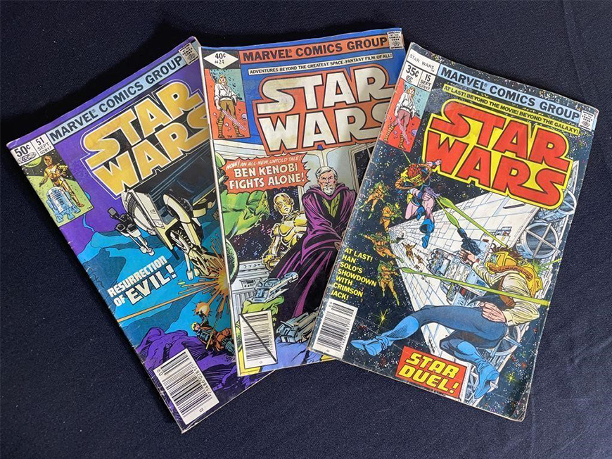 Three colorful Marvel Comics Group “Star Wars” comics fanned across a table. 