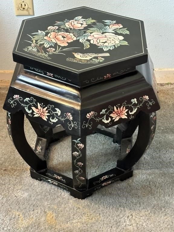 A 20th century Asian Chinoiserie black lacquered table with flowered design.