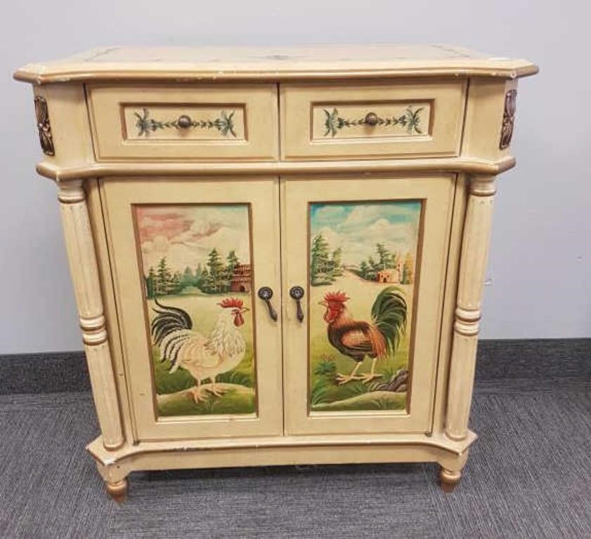 A cream-colored console cabinet decorated with depictions of a chicken and a rooster on a farm.
